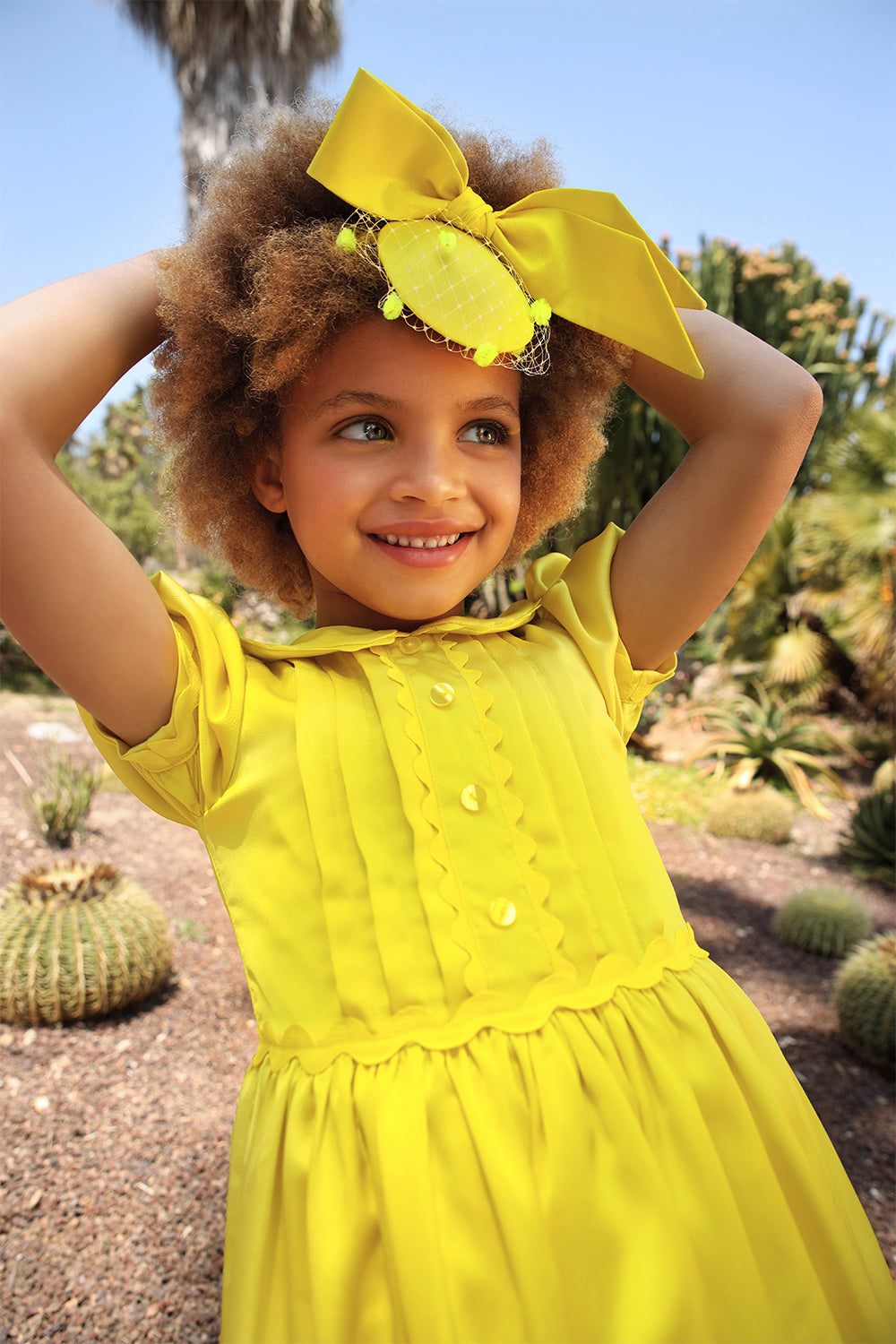 Bright yellow satin dress with pretty front detail, collar and puffed sleeves