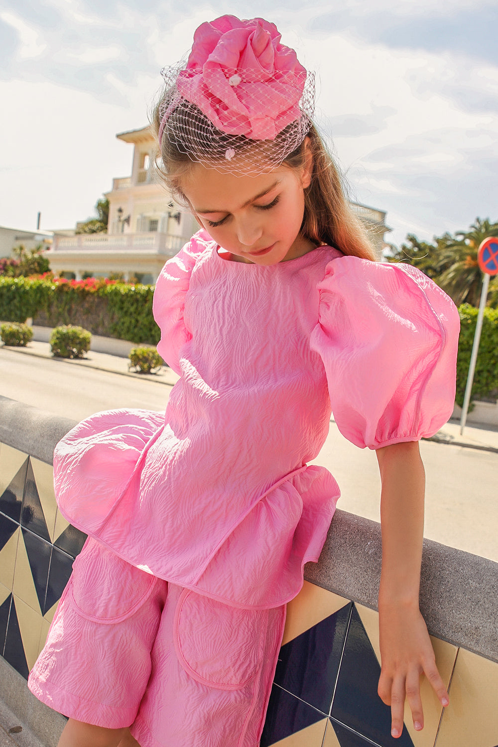 Bright pink jacquard top with voluminous sleeves and tie-up back straps