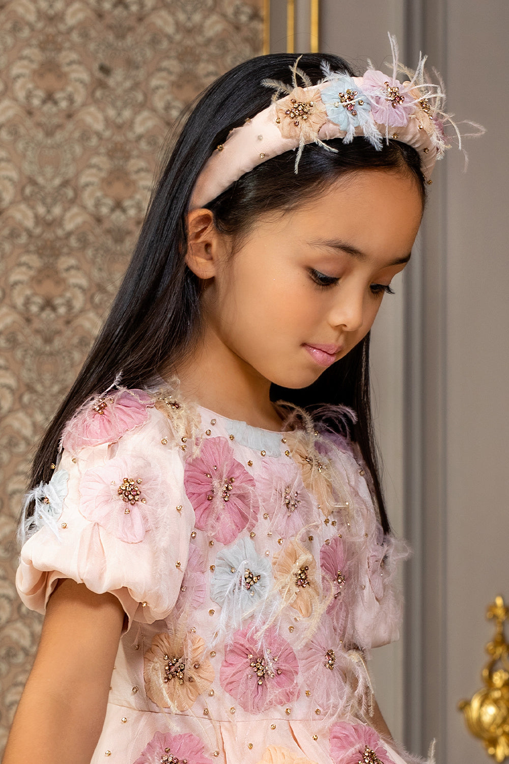 Pale pink headband with hand-embellishment of flowers with crystals and feathers