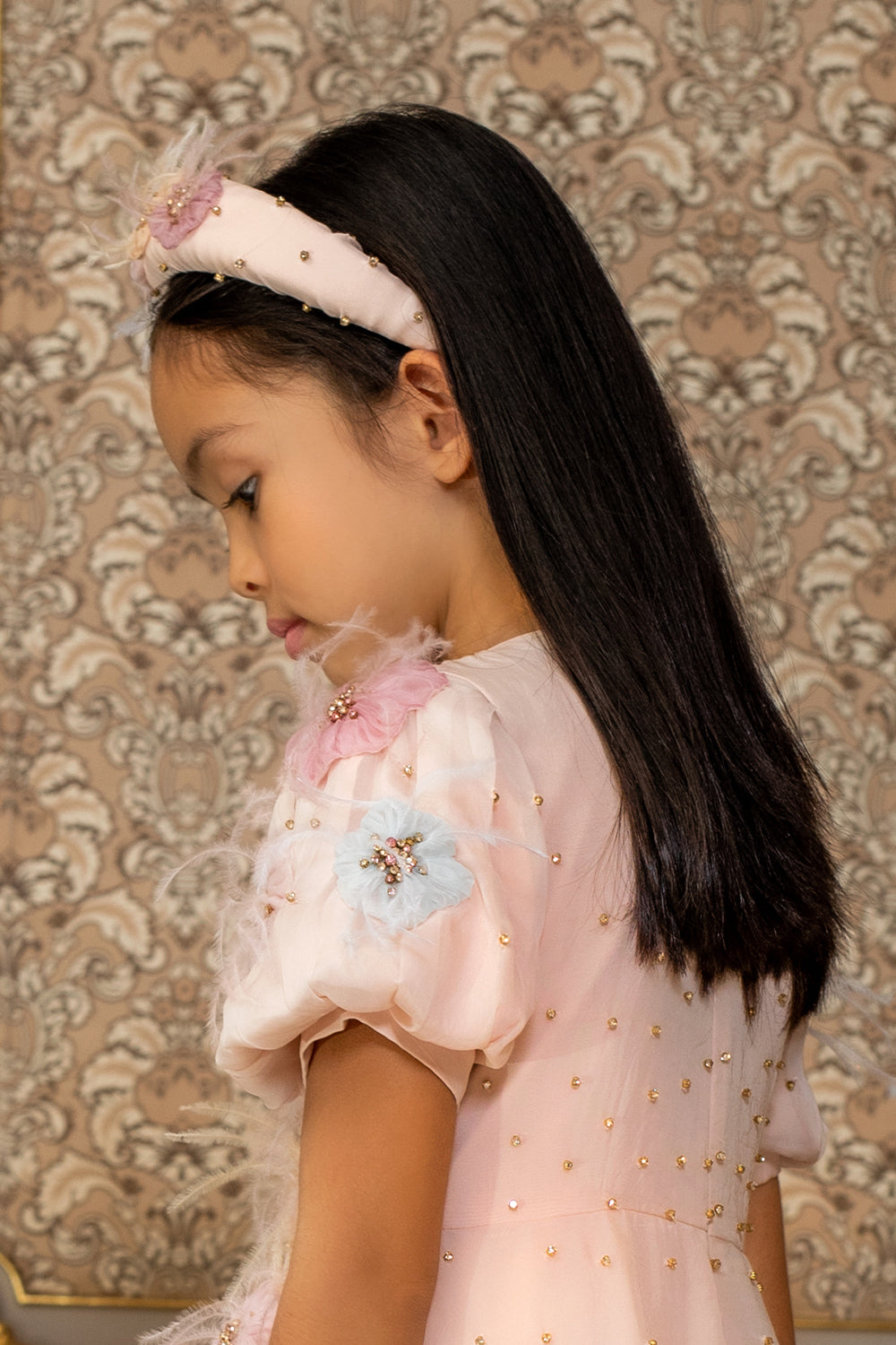 Pale pink headband with hand-embellishment of flowers with crystals and feathers