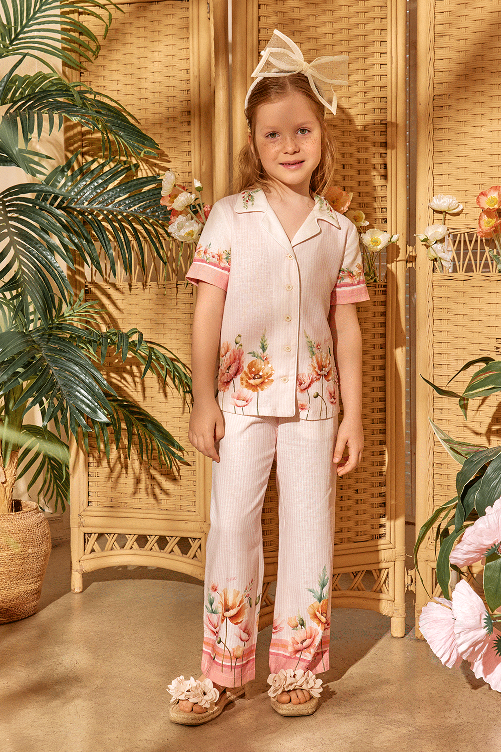 Soft pink striped set featuring a short-sleeve button-up shirt and matching pants with floral print and hand-embellished front