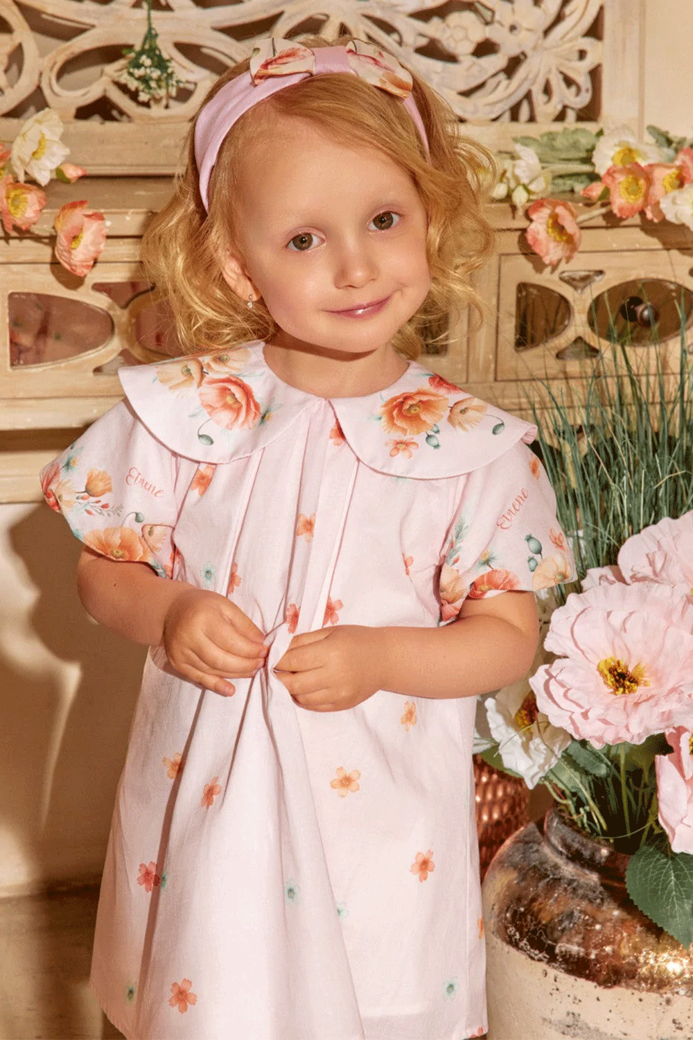 Soft pink dress with scattered floral prints, puff sleeves, and an oversized collar with flower accents