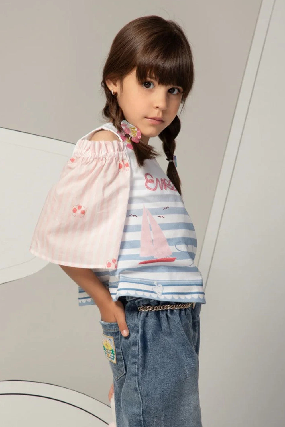 White and pink top with puff sleeves, striped pastel print and Eirene on the front