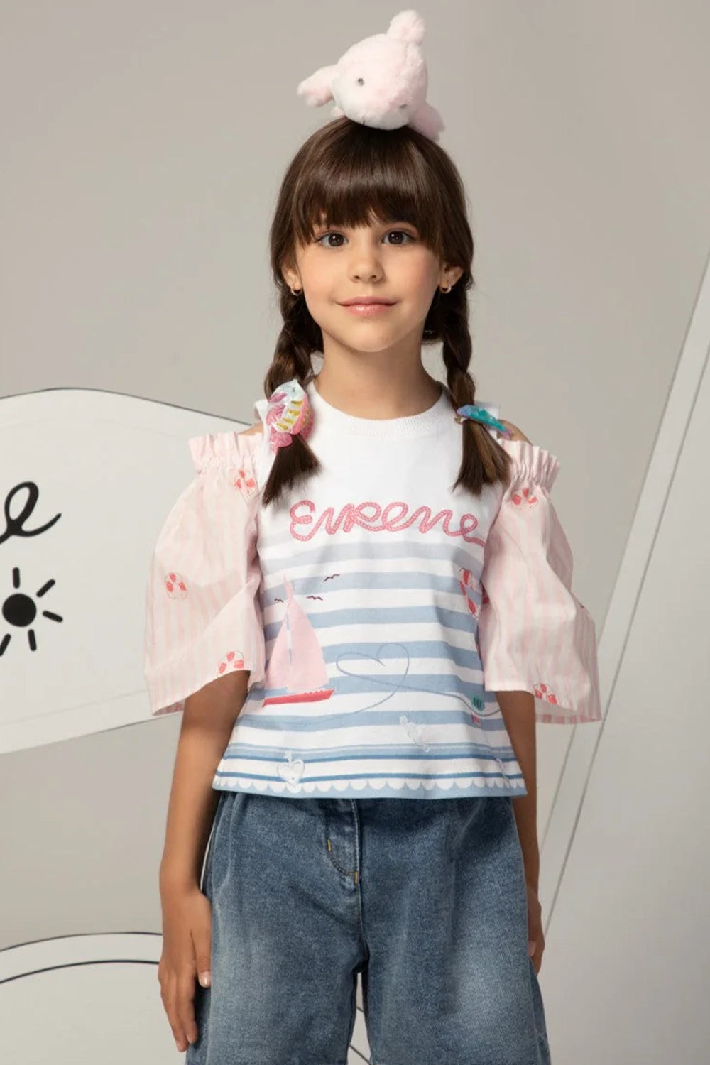 White and pink top with puff sleeves, striped pastel print and Eirene on the front