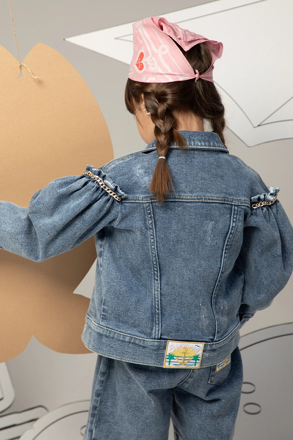 Denim jacket with puffed sleeves, heart gold chain details, and front button closure