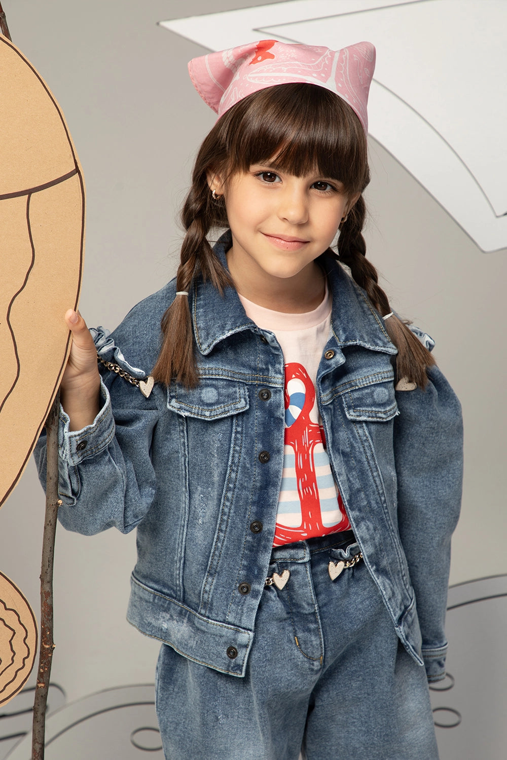 Denim jacket with puffed sleeves, heart gold chain details, and front button closure