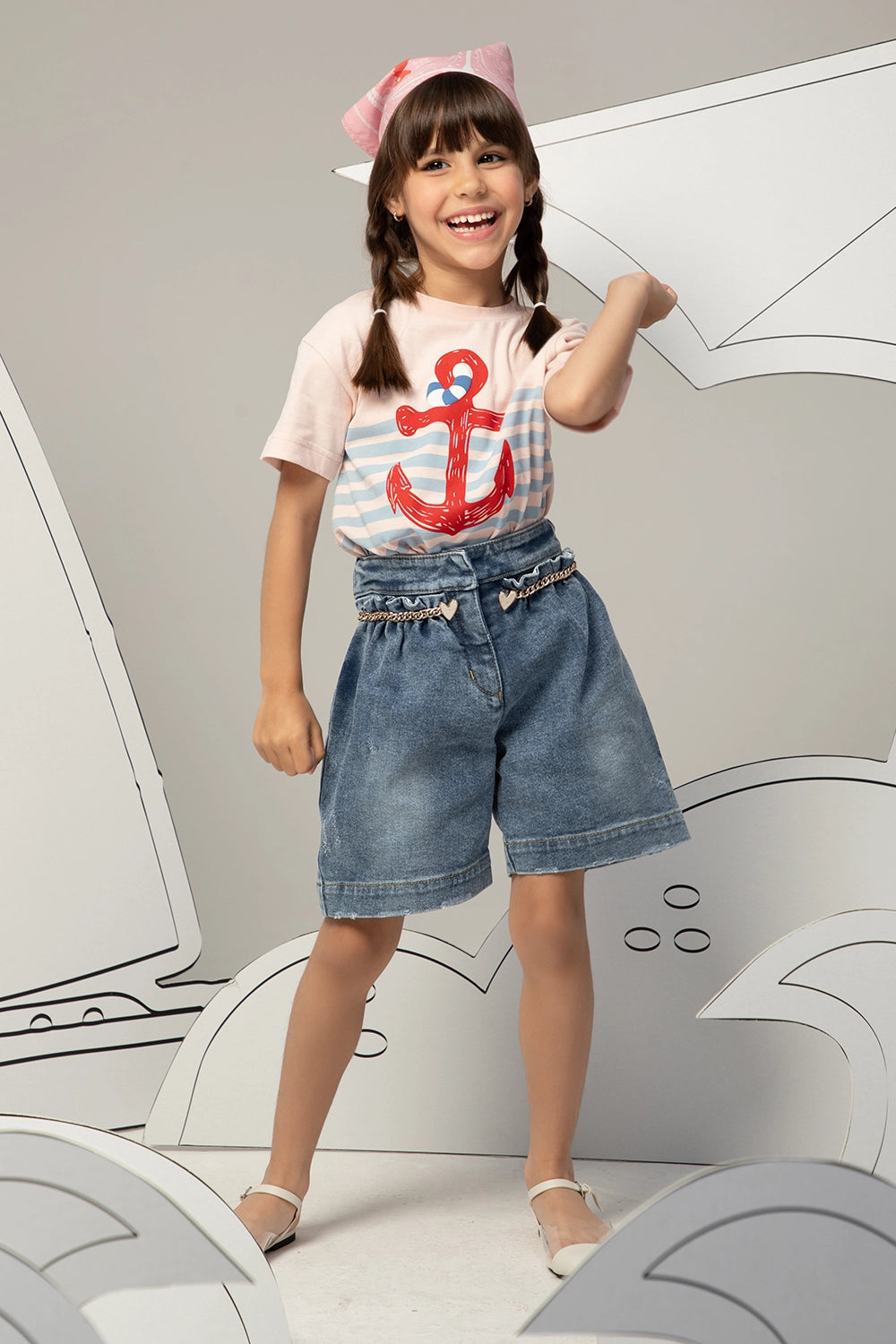 High-waisted denim shorts with a ruffled waistband, heart charm chain, and a relaxed, wide-leg fit