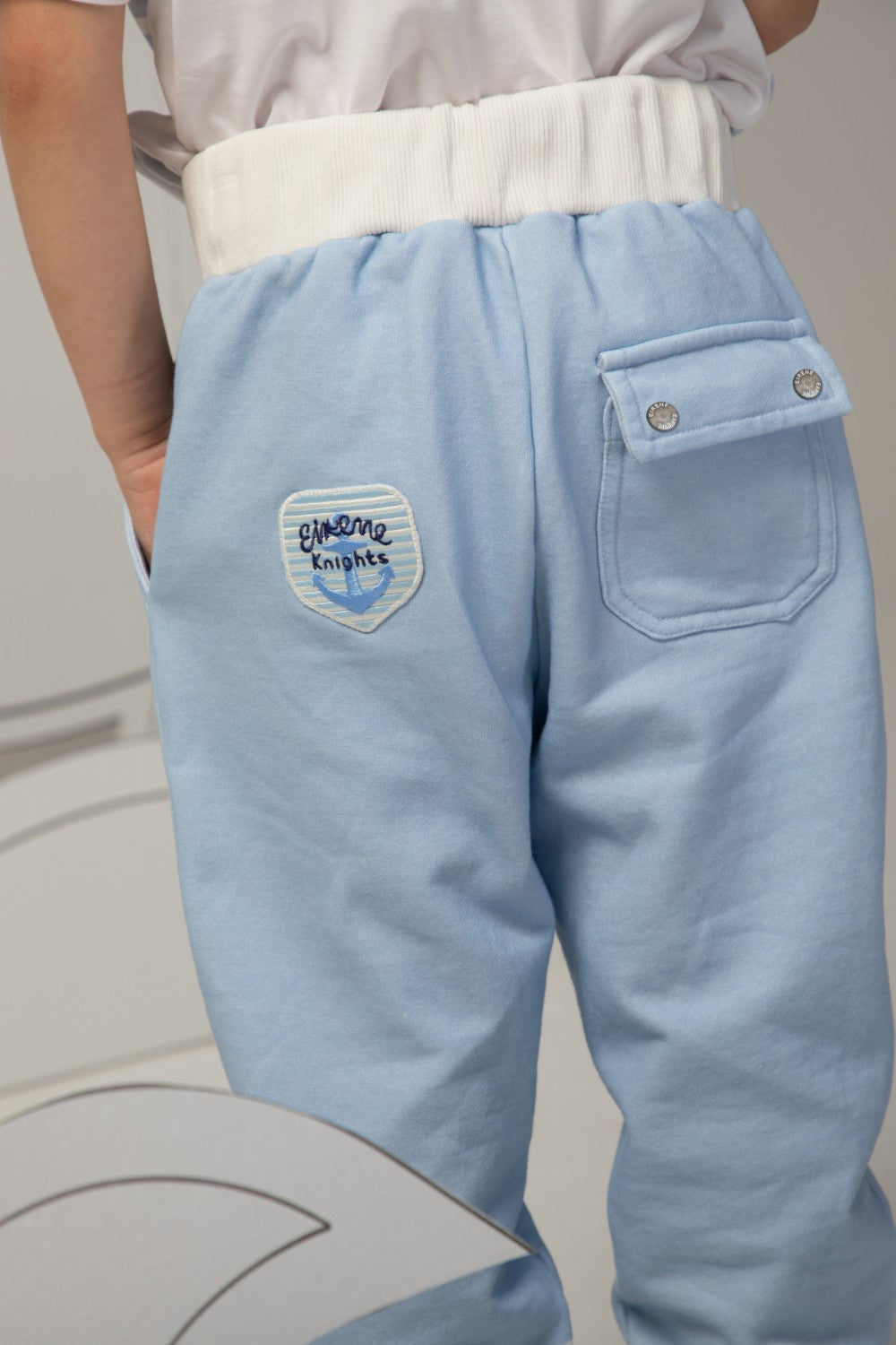 Off-white t-shirt with light blue stripes and a large red anchor print