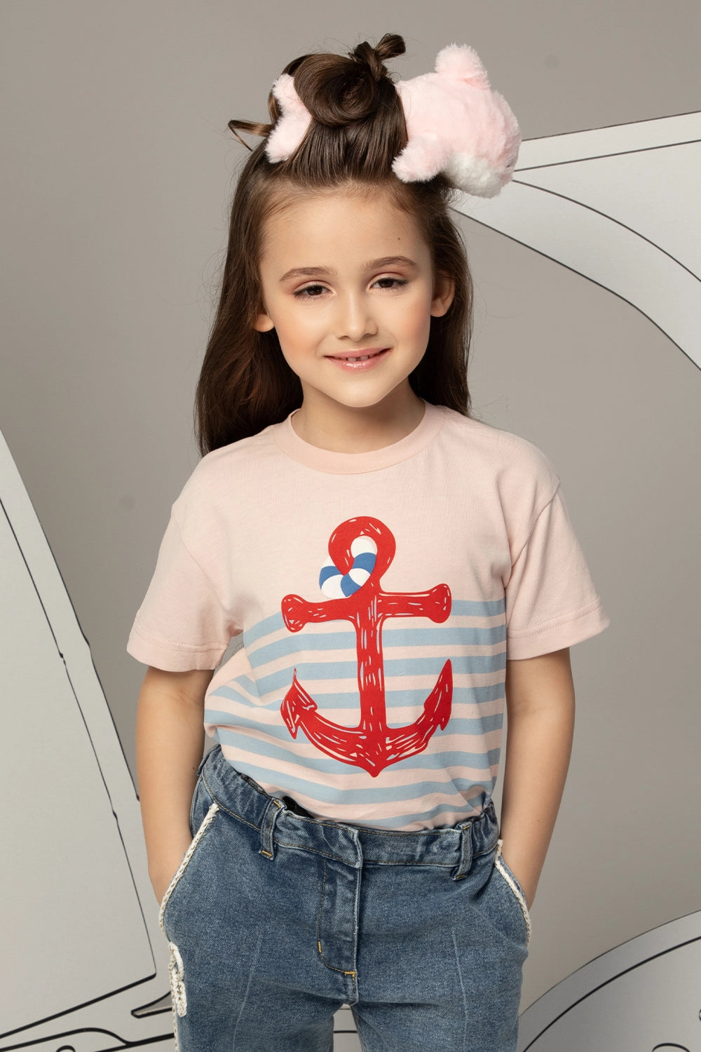 Pink t-shirt with light blue stripes and a large red anchor print