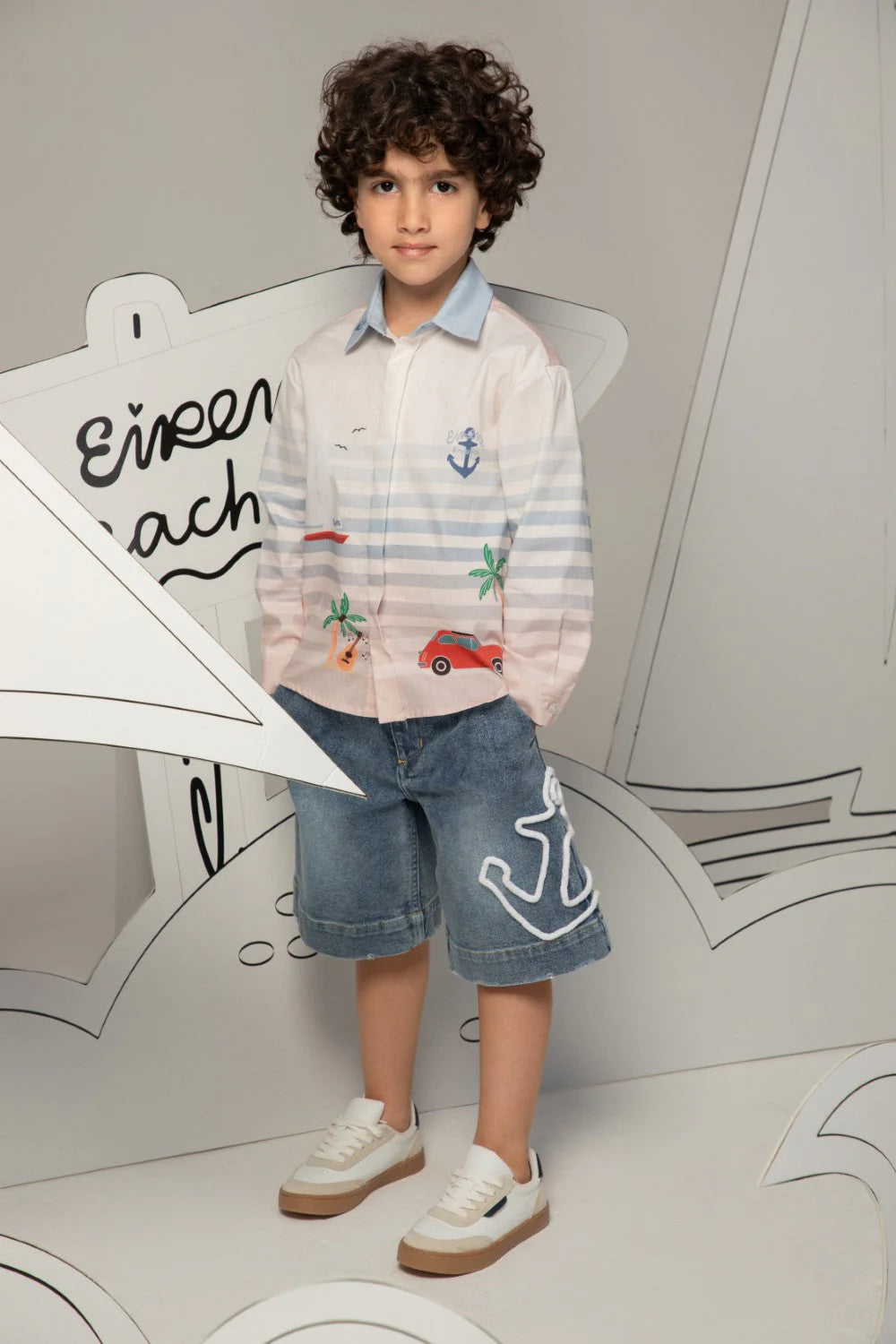 White button-up shirt with soft blue stripes and beach prints, finished with a light blue collar.