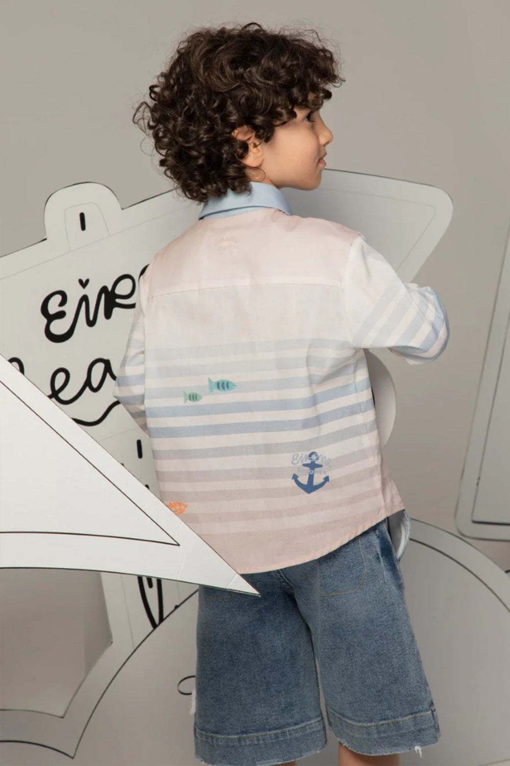 White button-up shirt with soft blue stripes and beach prints, finished with a light blue collar.