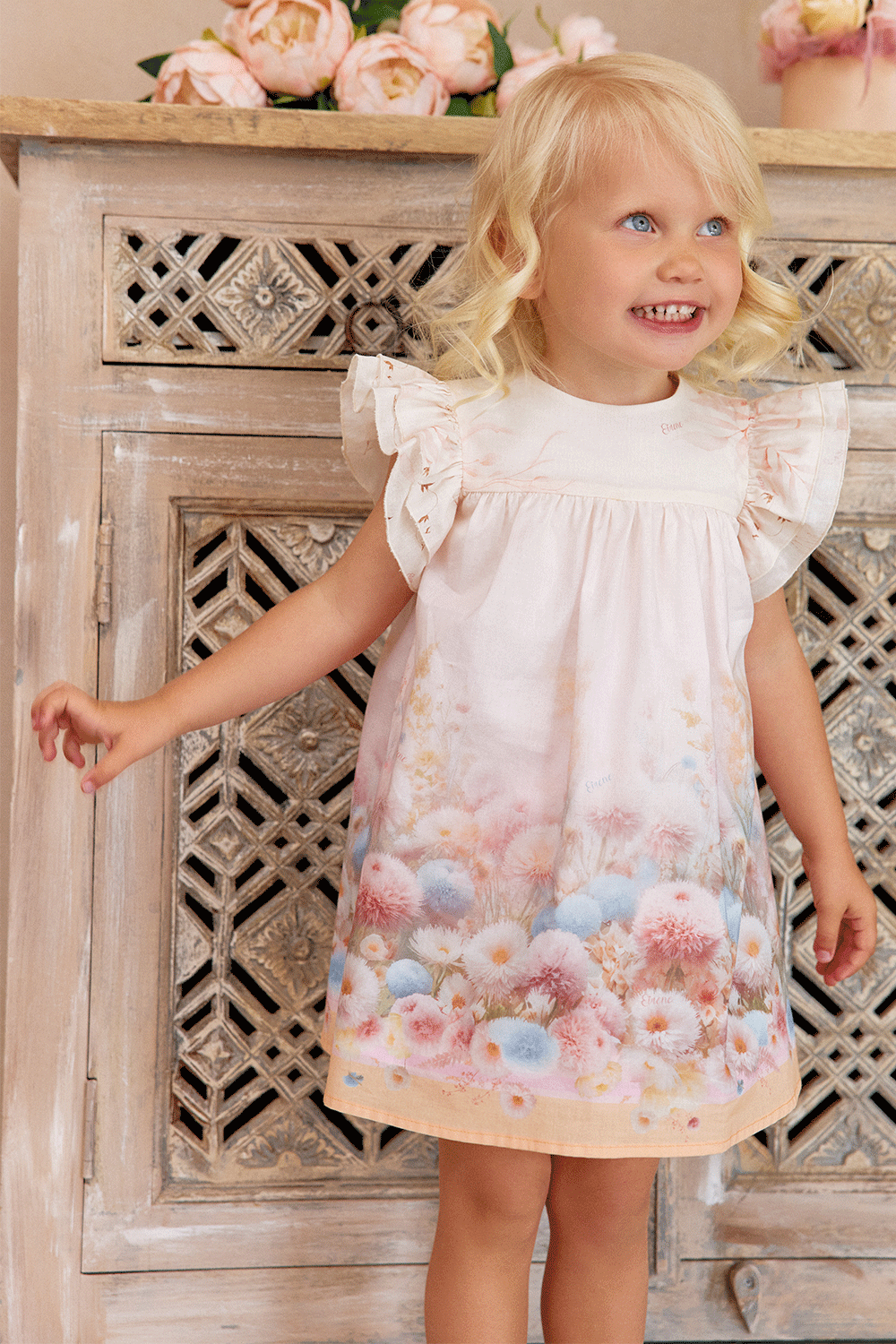 A-line cotton dress with ruffled shoulders and a dreamy pastel floral print