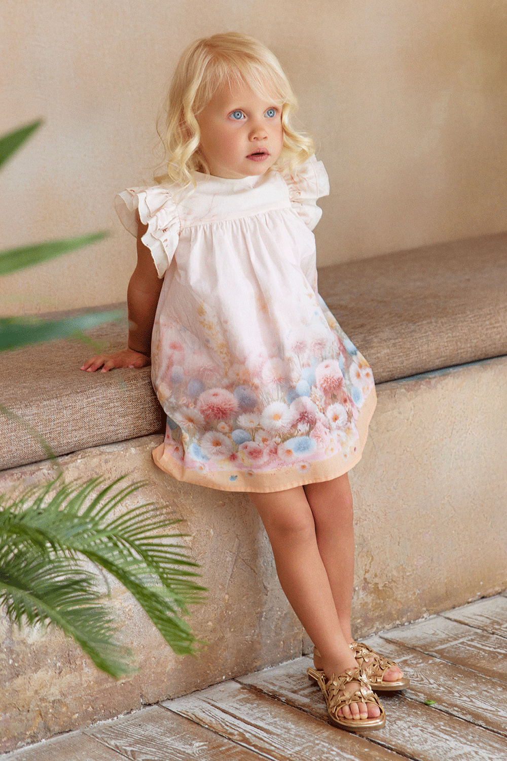 A-line cotton dress with ruffled shoulders and a dreamy pastel floral print