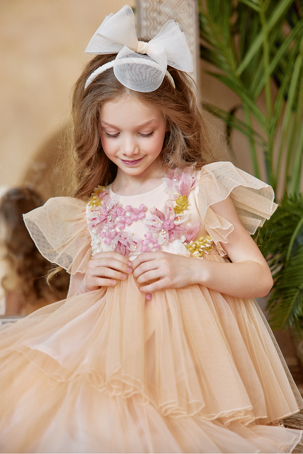 Peach tulle dress with flutter sleeves and hand-embellished 3D flowers