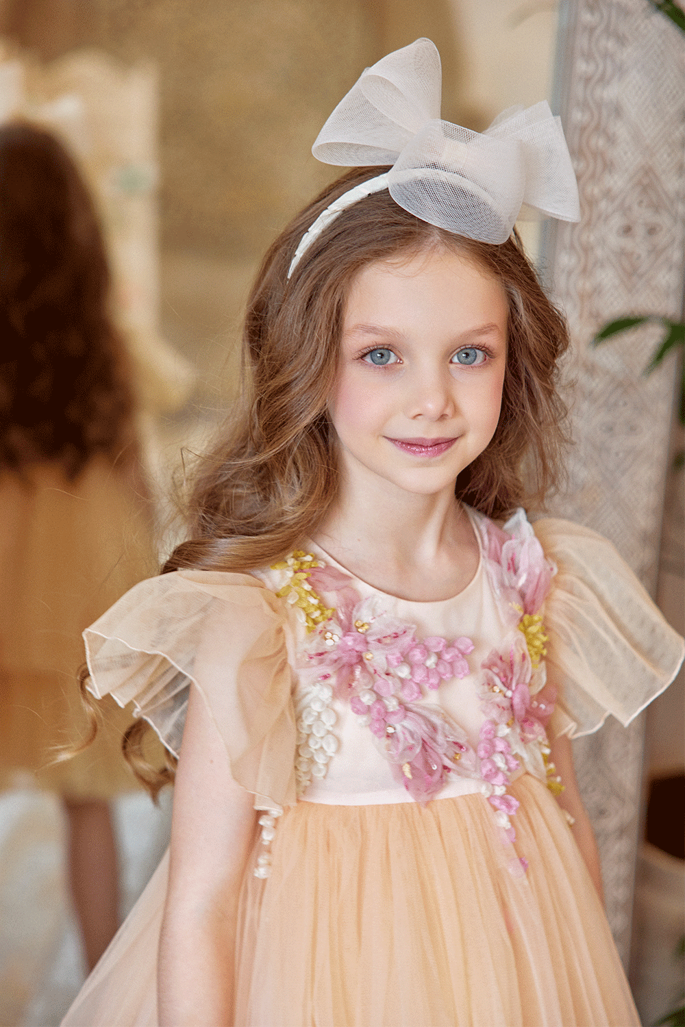 Peach tulle dress with flutter sleeves and hand-embellished 3D flowers
