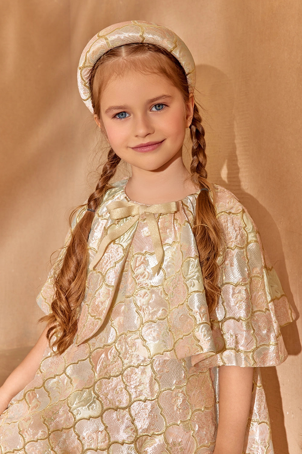 Brocade cape dress with a front bow and soft shine