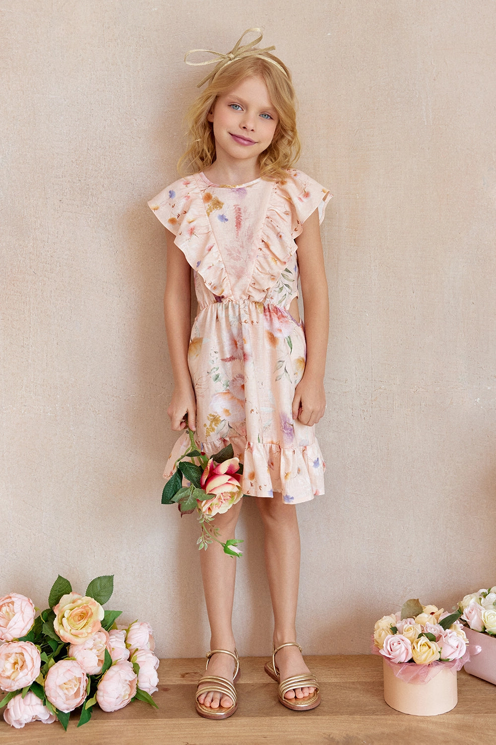 Floral linen dress with delicate side cutouts and soft pastel tones