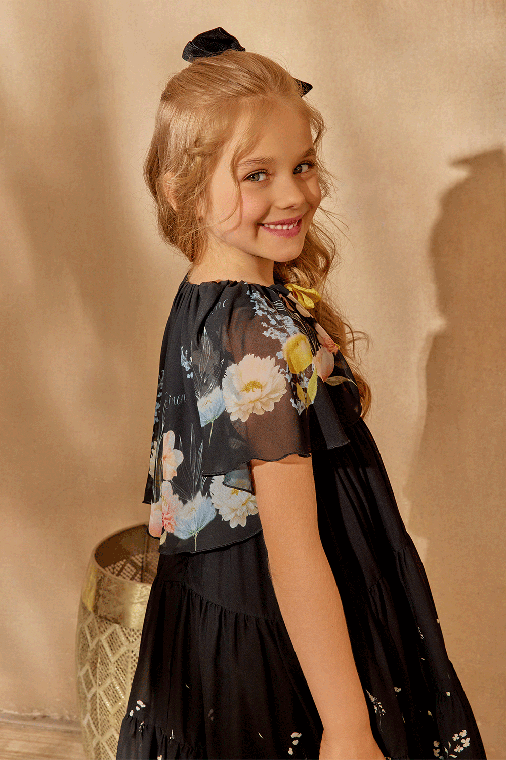 Black chiffon dress with floral cape and yellow bow detail