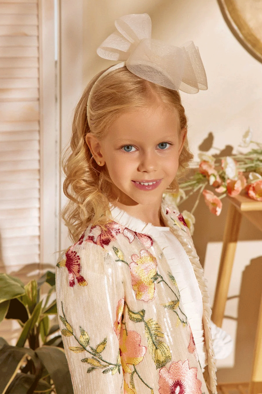 Ivory sequin set featurting a floral embroidered jacket with pleated trim and a matching mini skirt with frill