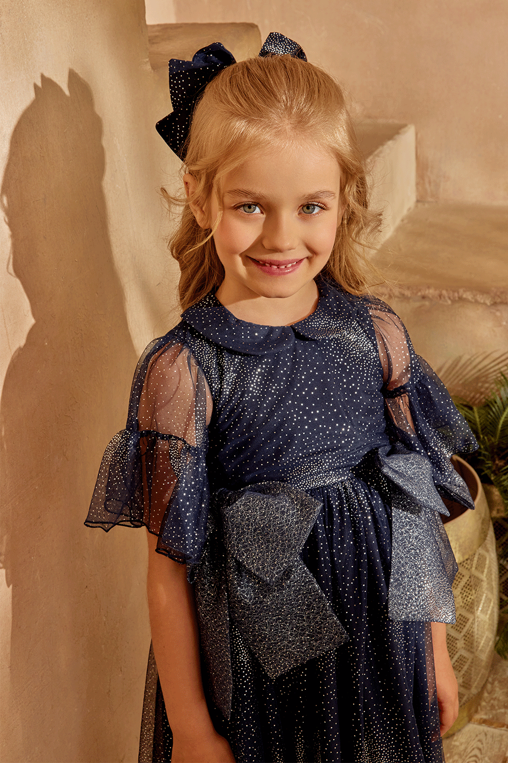Dark blue and silver dress with large bows and short sleeves