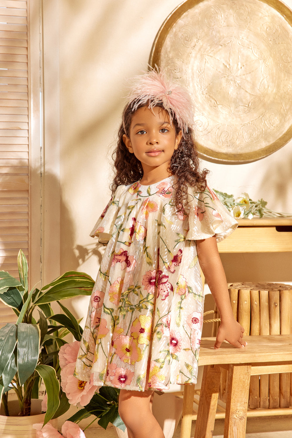 Girl posing in beautiful ivory sequin dress.