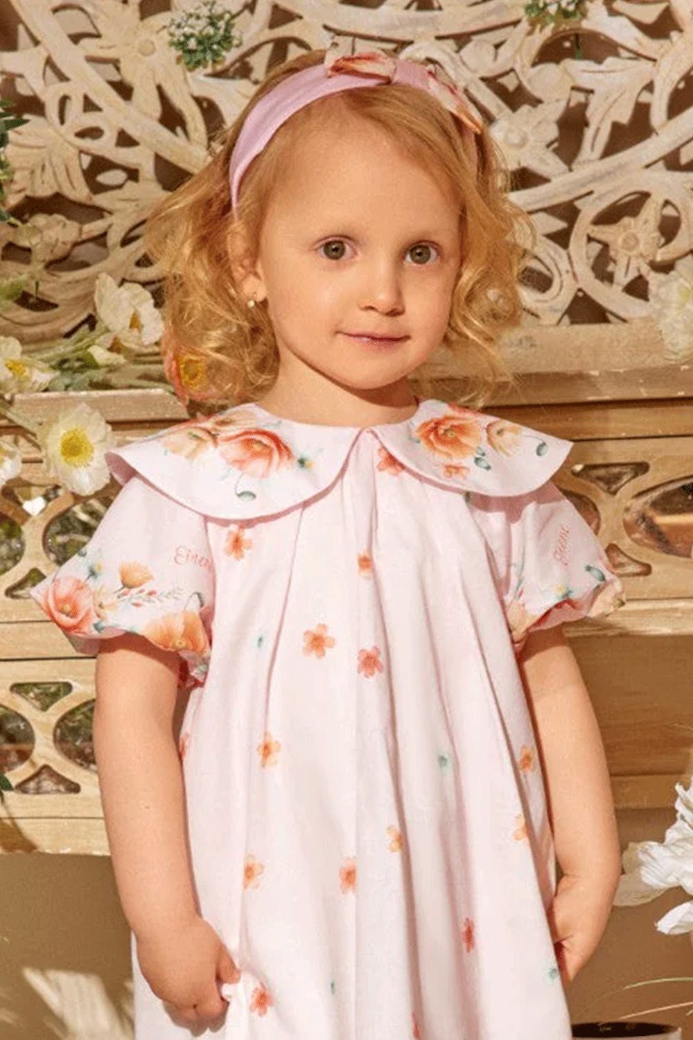 Soft pink headband with a charming bow, featuring delicate floral prints