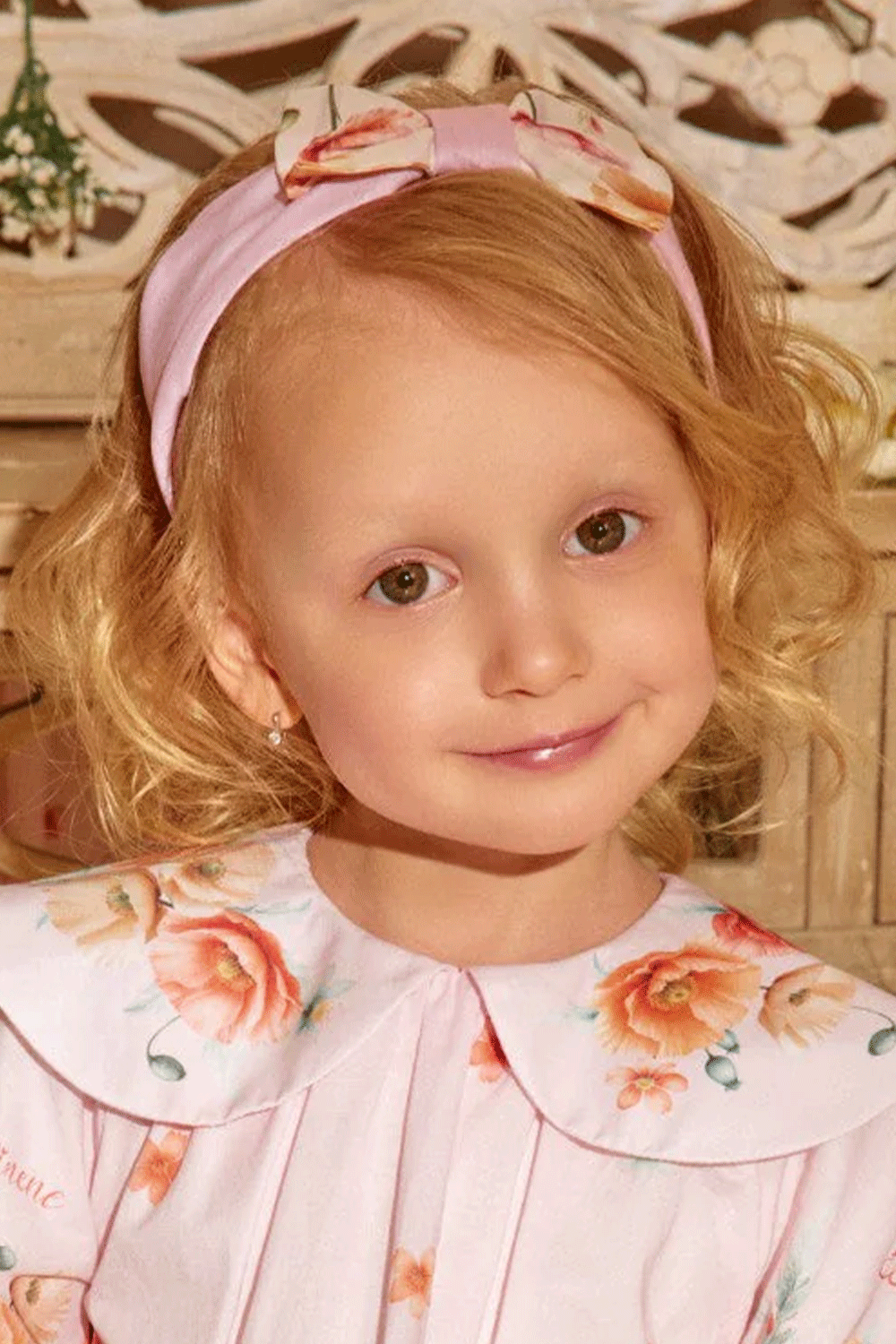 Soft pink headband with a charming bow, featuring delicate floral prints