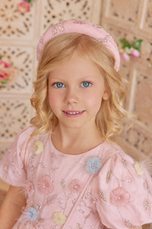 Pink padded hairband with hand-embellishments of floral and leaf motifs