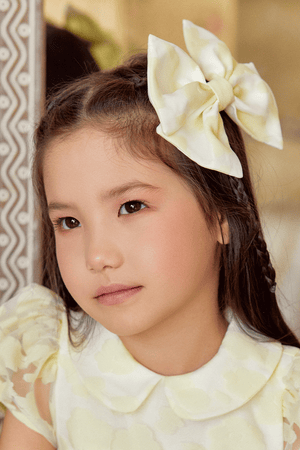 Oversized pale yellow bow hair clip in floral organza