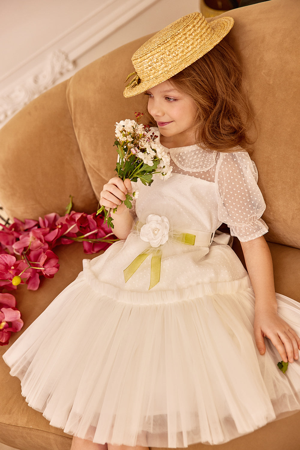 White tulle dress with green bow and flower